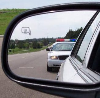 Police in rear view mirror